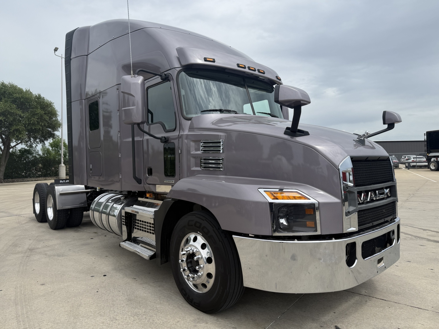 Mack AN64T70 conventional sleeper truck showing chrome front bumper and dual rear axles.