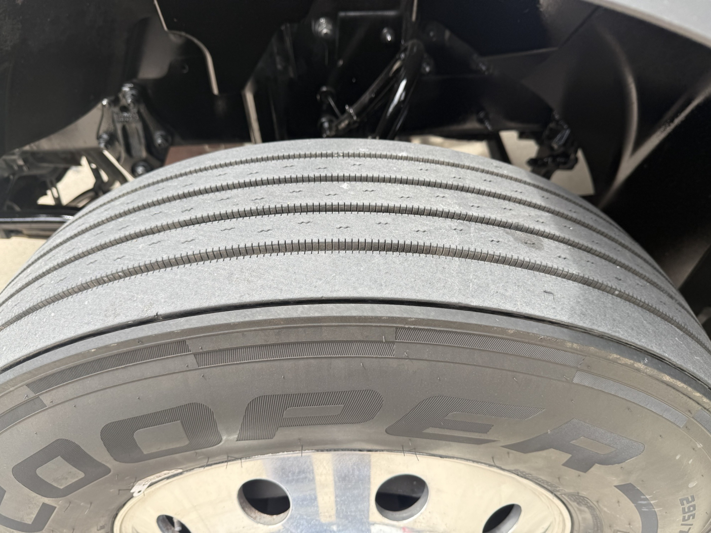 Truck front wheel and tire showing Goodyear tread with large 'Goodyear' lettering on the sidewall and wheel hub.
