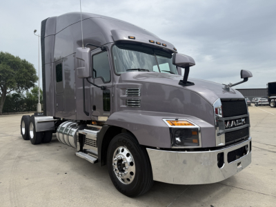 Mack AN64T70 conventional sleeper truck showing chrome front bumper and dual rear axles.