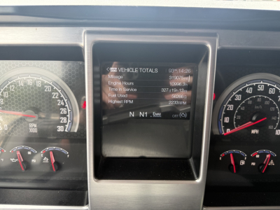 Dashboard view of 2023 Mack AN64T70 showing Vehicle Totals on central screen with mileage and RPM readouts, surrounded by gauge cluster.