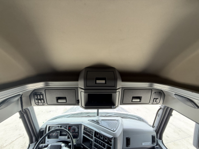 Truck cab interior overhead console with storage compartments and roof controls in a Mack AN64T70.