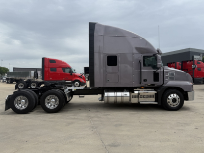 Side view of a gray Mack AN64T70 truck tractor showing sleeper cab and dual rear axles.