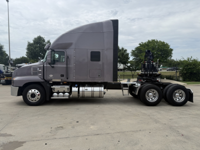 Mack AN64T70 conventional sleeper tractor in side profile showing cab with sleeper, fuel tanks, and dual rear axles.