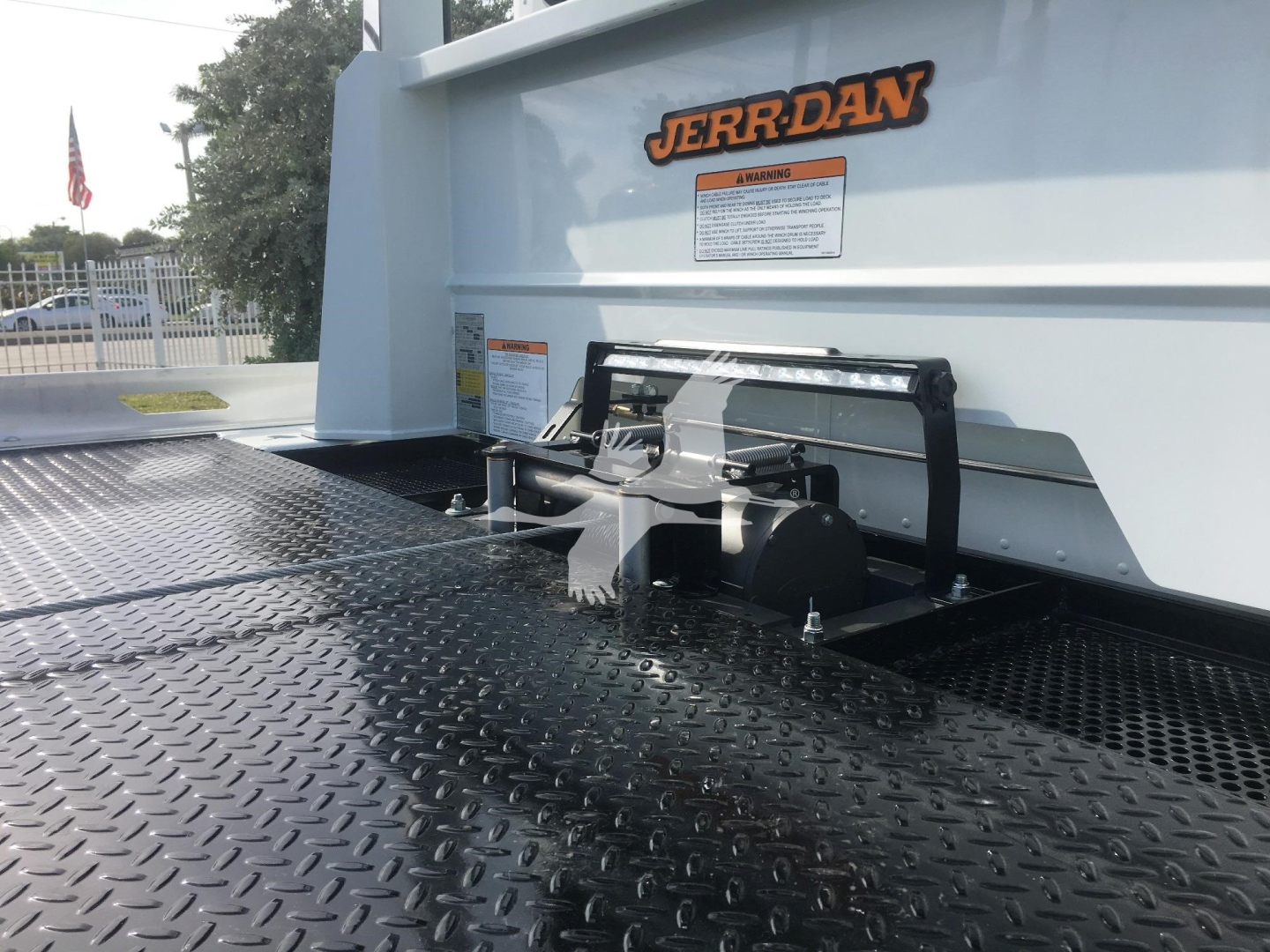 Peterbilt 337 rollback truck bed with JERR-DAN branding and hitch/attachment hardware on a diamond plate steel deck.