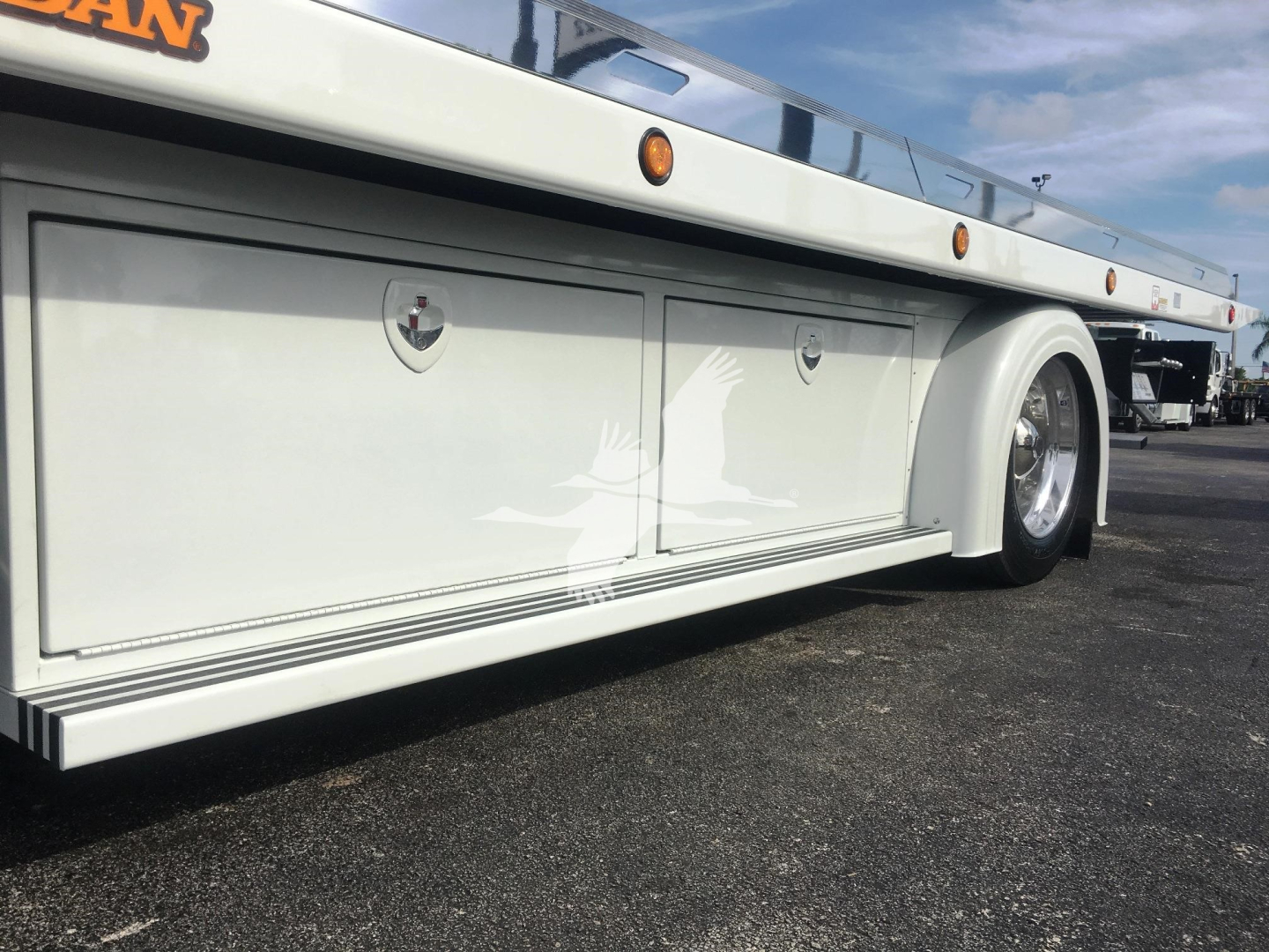 Peterbilt 337 rollback truck body side paneling with storage compartments and wheel, white color.