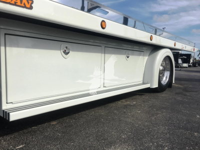 Peterbilt 337 rollback truck body side paneling with storage compartments and wheel, white color.
