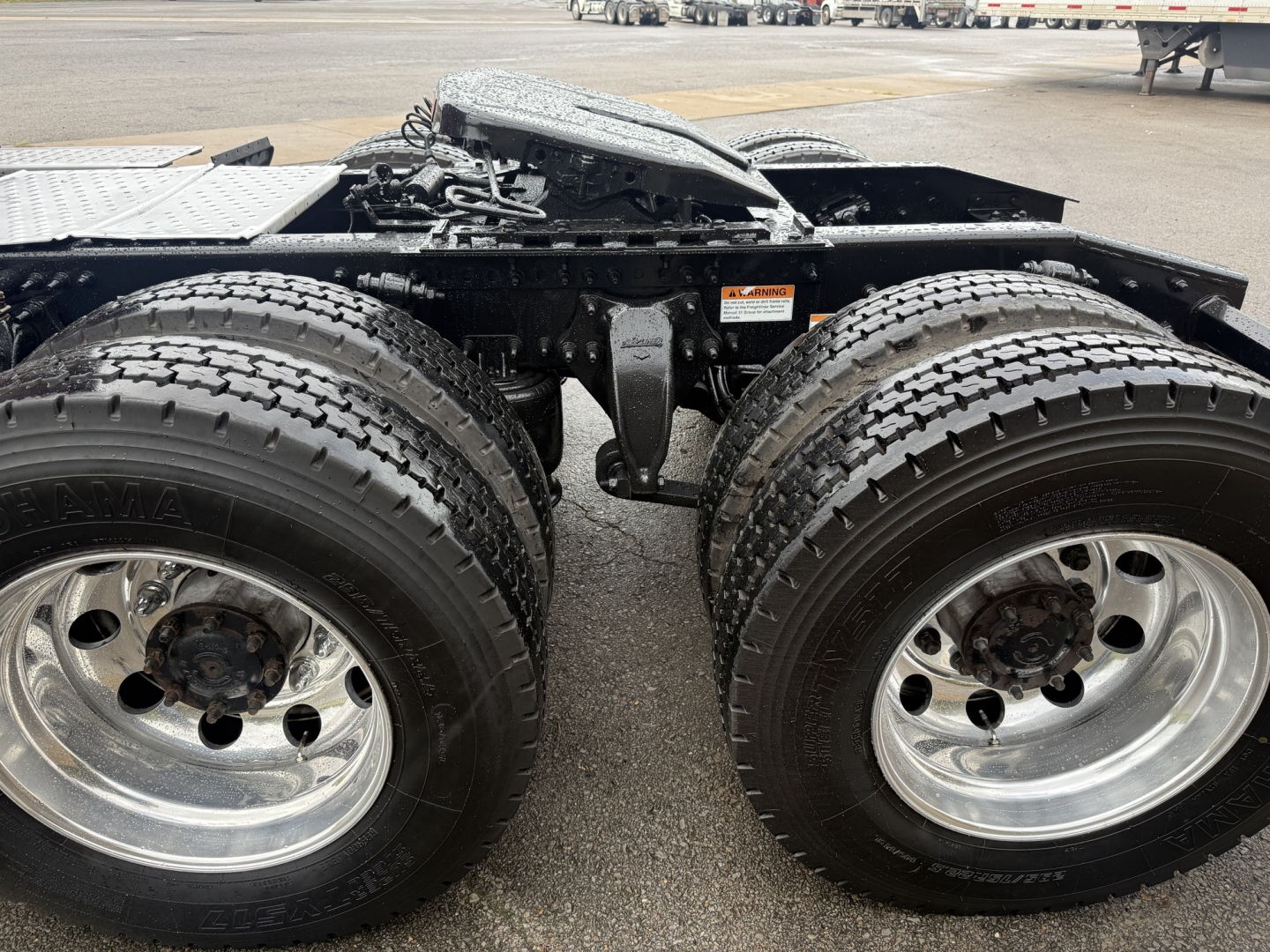 Freightliner Cascadia 126 chassis and dual rear axles showing heavy-duty wheels and tires with metallic rims.