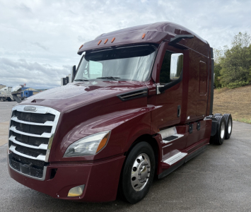 Curtain-side Freightliner Cascadia 126 truck in maroon, front three-quarter view; visible text includes Freightliner emblem on grille, no other legible labels.