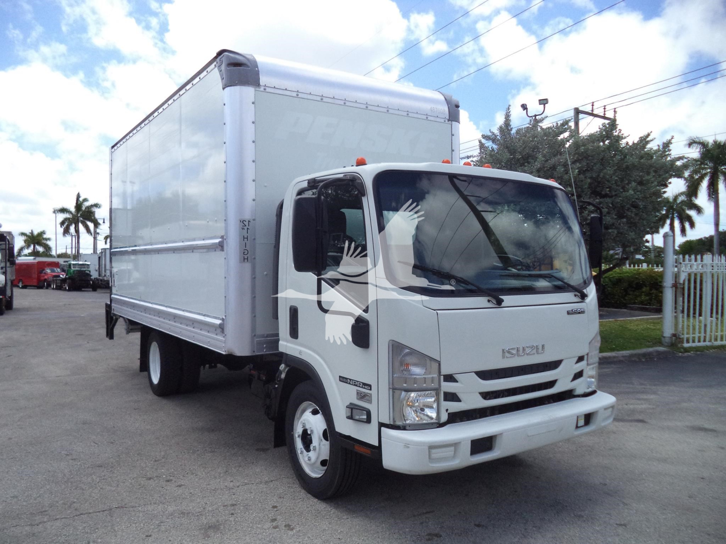 Isuzu NPR-HD box truck in view showing cab and cargo box with white exterior.