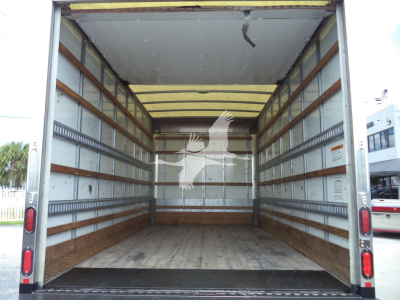 Isuzu NPR-HD box truck cargo area with empty wooden floor and metal side rails.