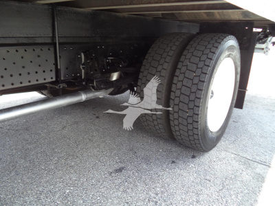 Isuzu NPR HD rear dual wheels and undercarriage showing suspension components and frame.