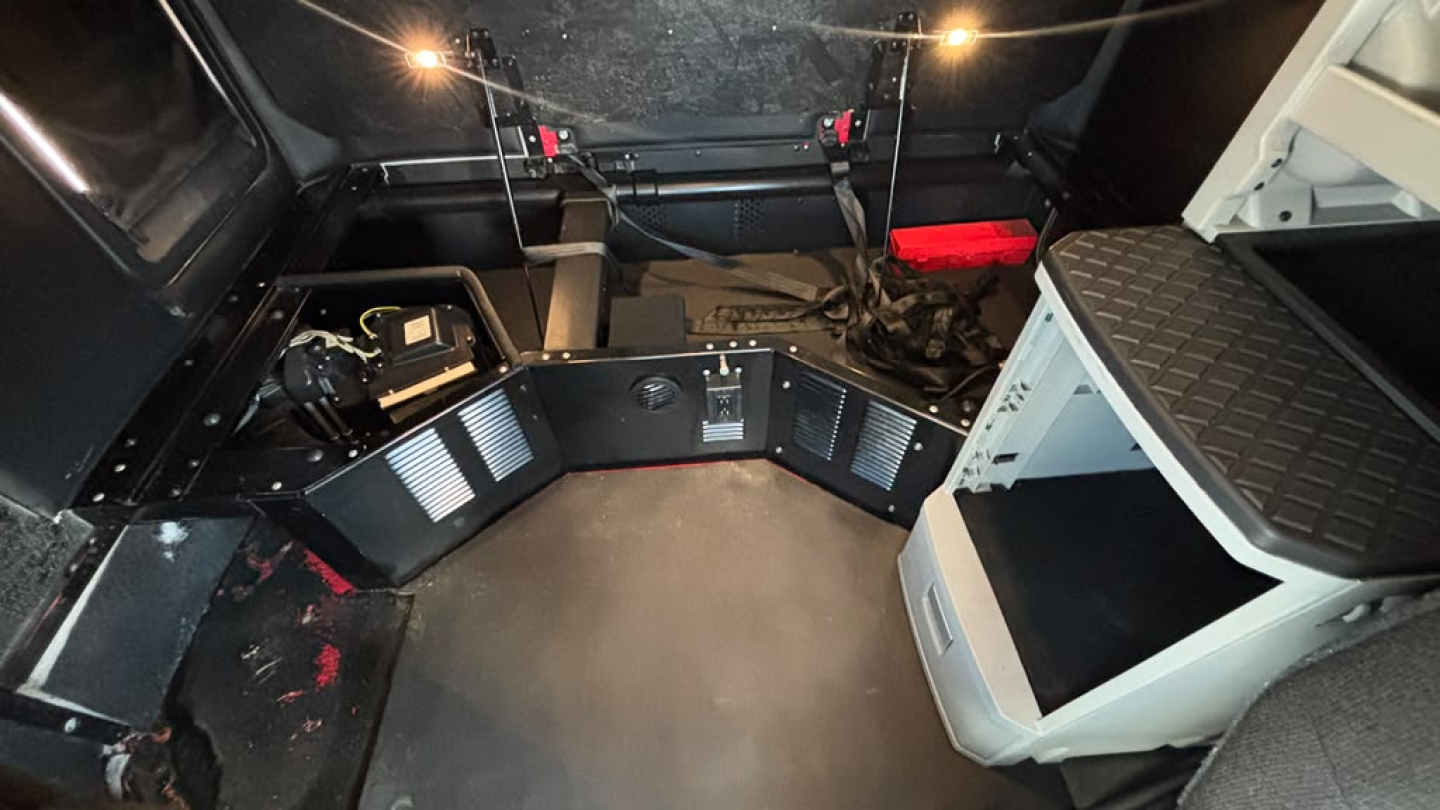 Kenworth T680 sleeper cab interior cargo area with metal floor and control panels on sides