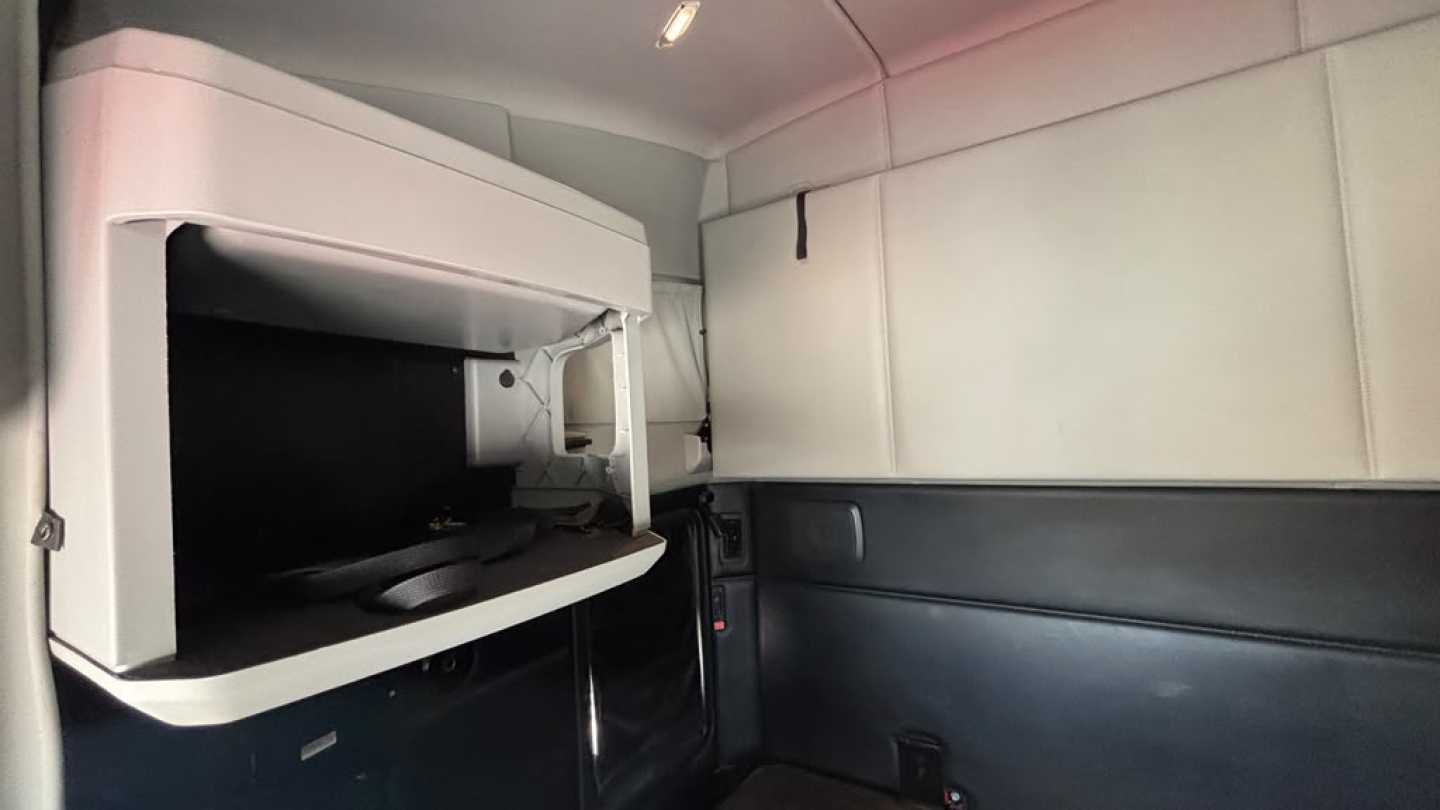 Kenworth T680 sleeper cab interior showing upper bunk and storage compartments