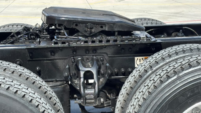 Kenworth T680 truck chassis view showing rear frame and dual rear tandem suspension, with air cab mounts and fuel/air lines; visible tires and frame members.