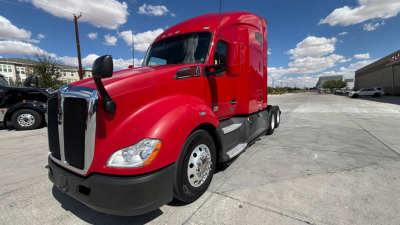 Kenworth T680 tractor in red color, side view showing front grille, passenger side, and sleeper cab with wheels and mud flaps.