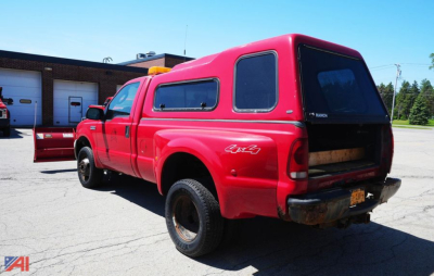 Ford F-350 XL SD dually pickup with plow and cap, red extended cab rear view showing bed cap and 4x4 badge