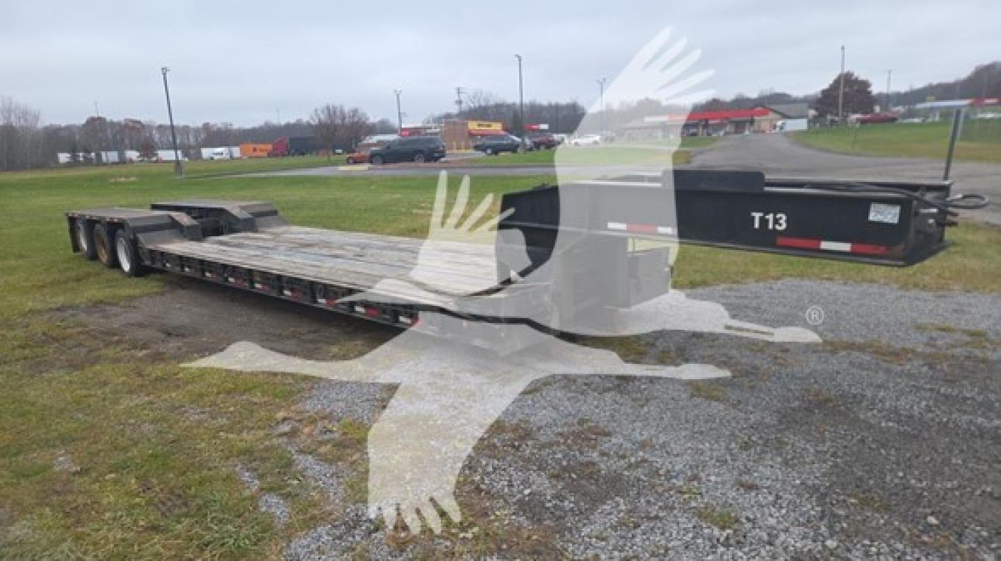 Rogers 50 Ton lowboy trailer with long flatbed and rear multiple axles; side shows 'T13' on the front.