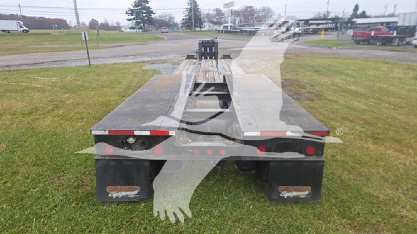 Rear view of a Rogers 50 Ton lowboy trailer showing dual rear mud flaps and deck with ramps.