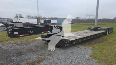 Ground bearing lowboy trailer showing long flatbed with multiple axles and rear ramp, label T13 on tongue.