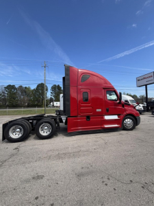 Red Freightliner Cascadia 126 semi truck side profile showing sleeper cab and chassis.
