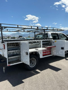 2020 Ford F350 service body with compartments open, side view showing storage drawers and ladder rack.