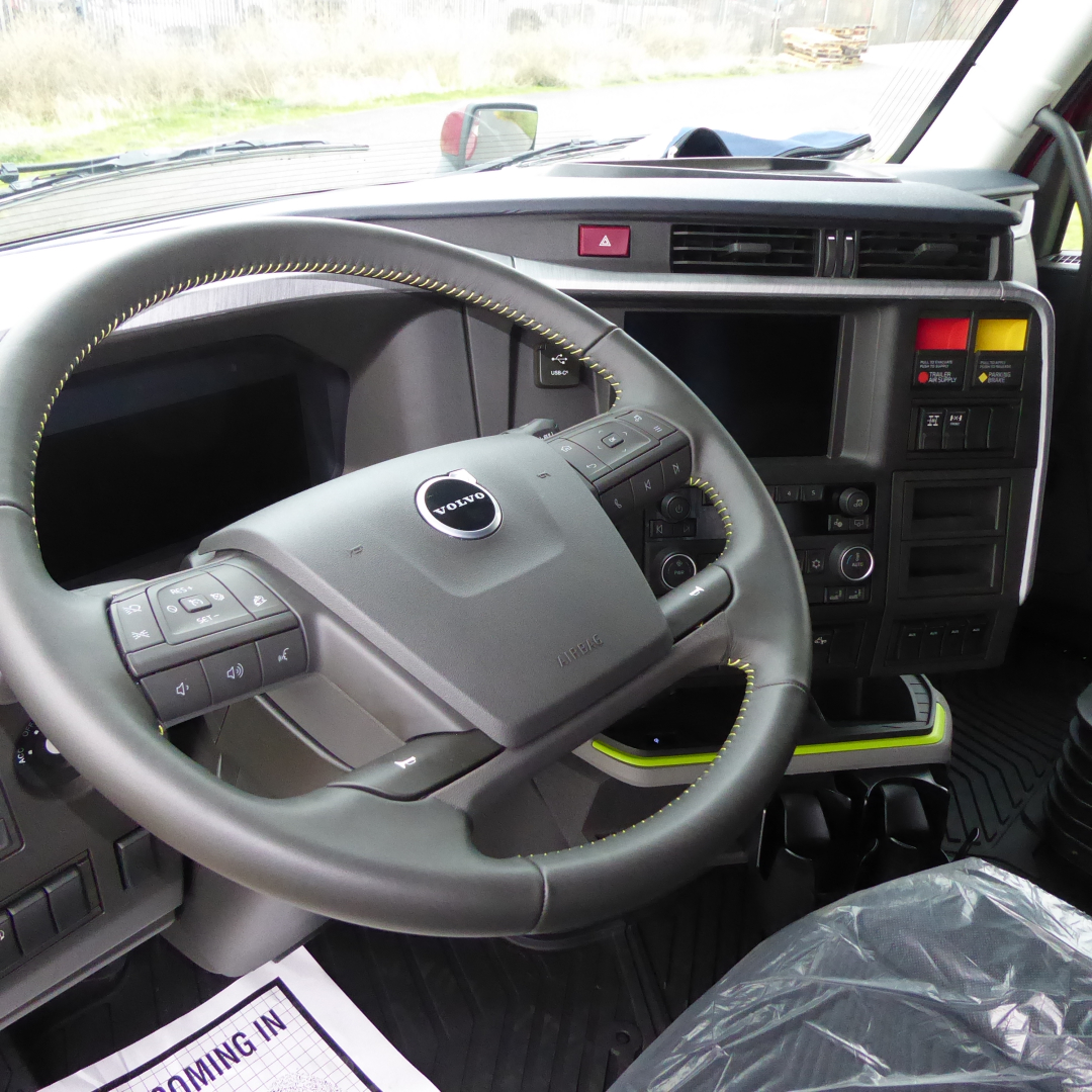 Volvo VNL64T860 truck cockpit showing steering wheel and dashboard controls.