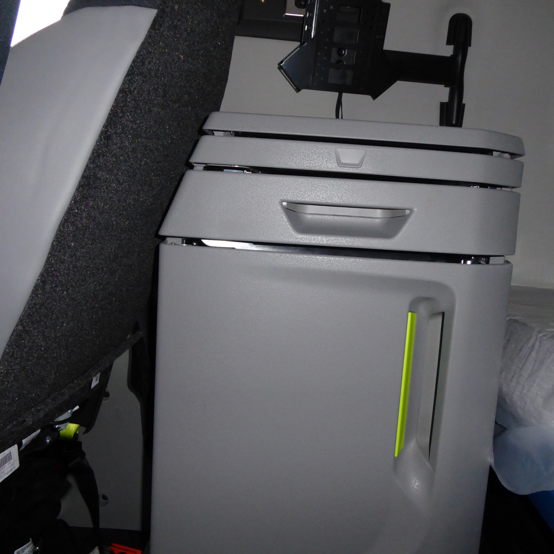 Volvo VNL64T860 interior sleeper area with storage cabinet and vertical yellow-green level indicator.