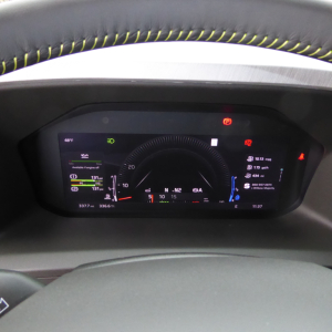 Volvo VNL dashboard and steering wheel with digital gauge cluster in view showing instrument panel and small status icons.
