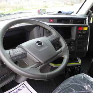 Volvo VNL64T860 truck cockpit showing steering wheel and dashboard controls.