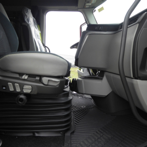 Volvo VNL64T860 truck interior showing driver seat controls and entry floor mat.