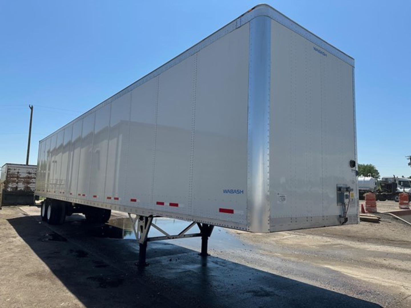 Wabash Duraplate dry van trailer side and front showing rear doors and landing gear.