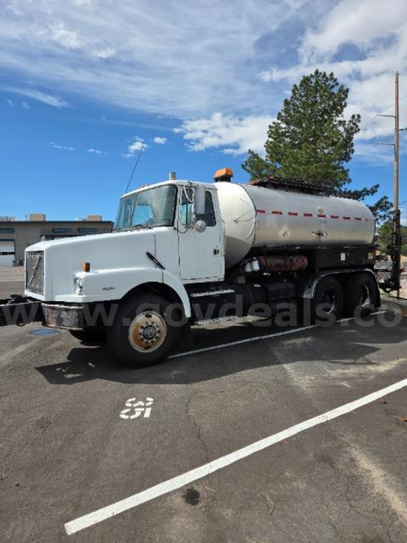 Volvo S2000 fuel/steam truck with cylindrical stainless tank mounted on chassis, front cab, white color, side view