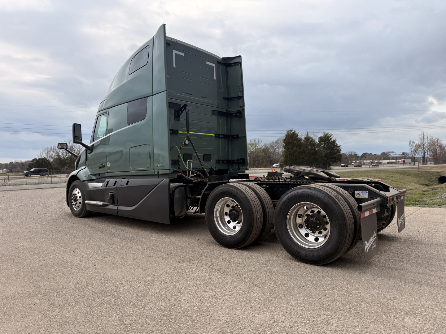 2027 Volvo VNL64T860 tractor cab and chassis side view showing sleeper cab, dual rear axles, and fifth wheel area.