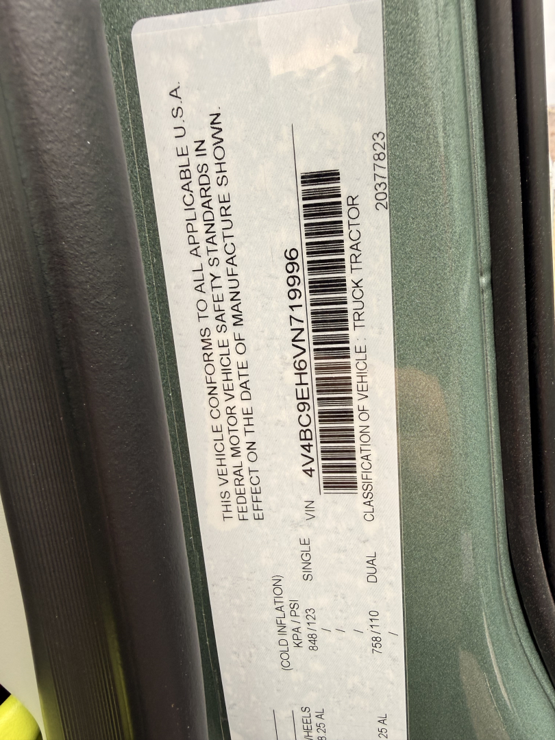 Vehicle information sticker on Volvo truck door: VIN 4V4BC9EH6VN719996, stock 71870, label with tags and barcode, classification includes ‘Truck Tractor’ and ‘Single Vehicle’ details.