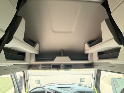 Volvo VNL64T860 cab interior overhead view showing storage compartments and dash area.