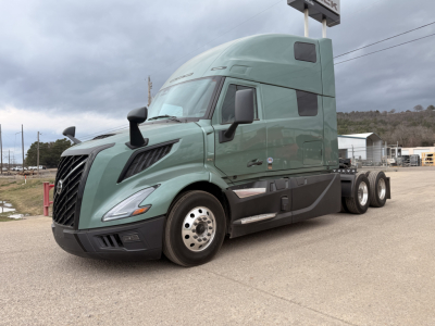 Volvo VNL64T860 heavy truck cab view with green paint and sleeper, front three-quarter angle, stock number 71870 on lot.