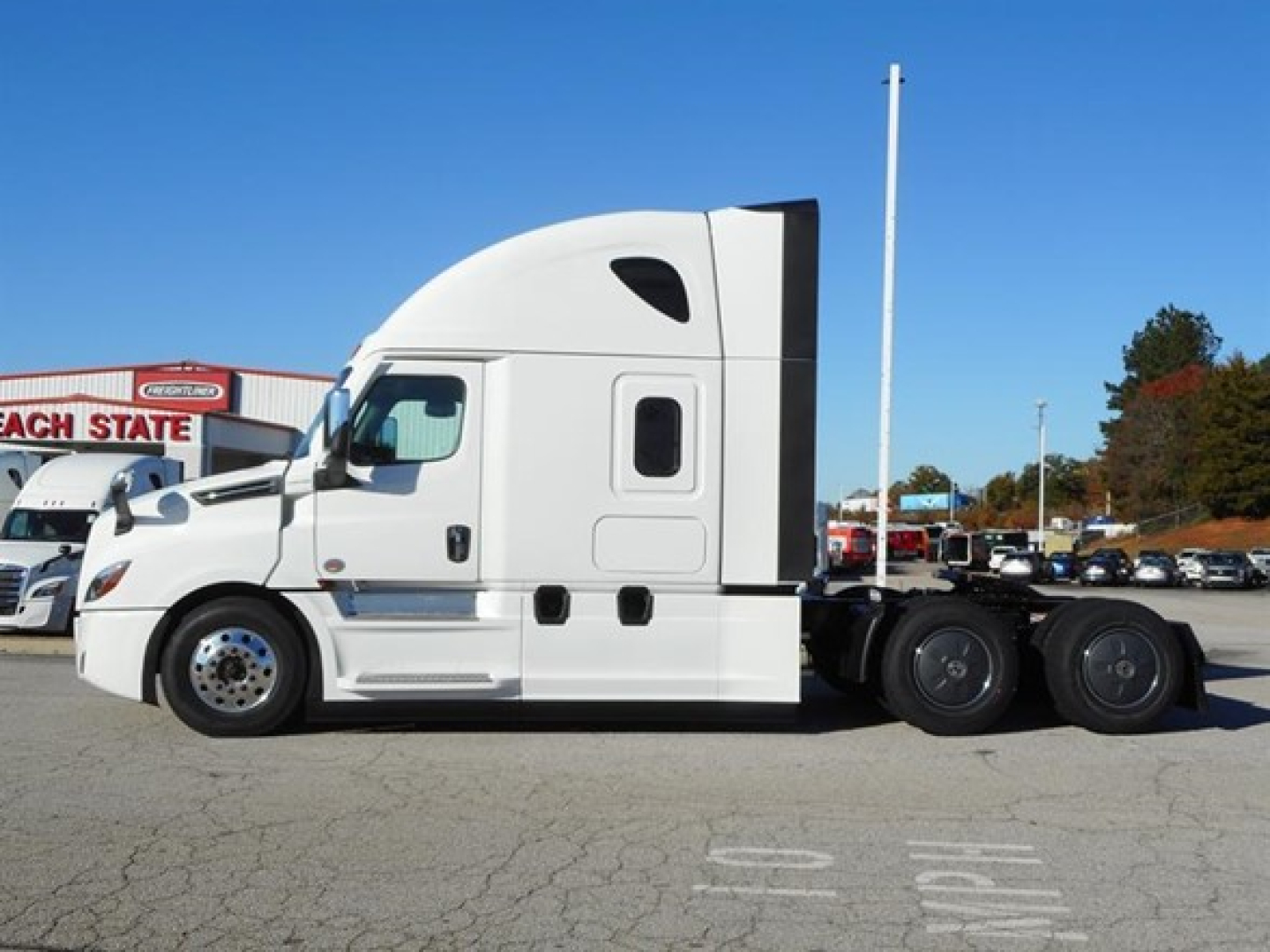 Freightliner Cascadia 126 tractor side view with sleeper cab and dual rear axles. Visible label on the truck reads 2027 Freightliner Cascadia 126.