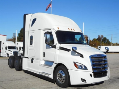Truck cab exterior showing large white Freightliner Cascadia 126 sleeper tractor with extended hood, chrome grille, and dual rear axles.