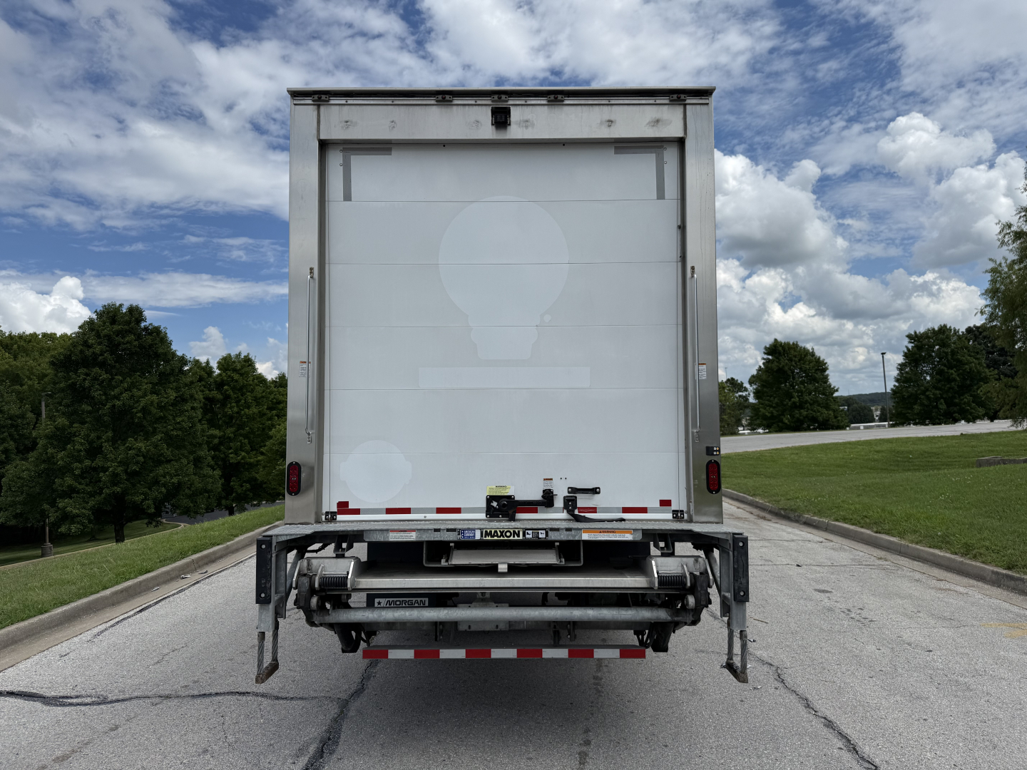 Kenworth T380 refrigerated truck rear view showing cargo area and liftgate with red/white reflective tape