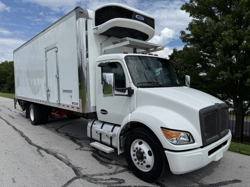 Kenworth T380 refrigerated truck with a front grille, cab mirrors, and a mounted unit on the over-cab. White cab, large box trailer with a YORK refrigeration unit visible on top.