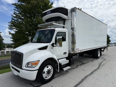 Kenworth T380 refrigerated truck with front hood, attached box, and mounted refrigeration unit on top, in a parking lot.