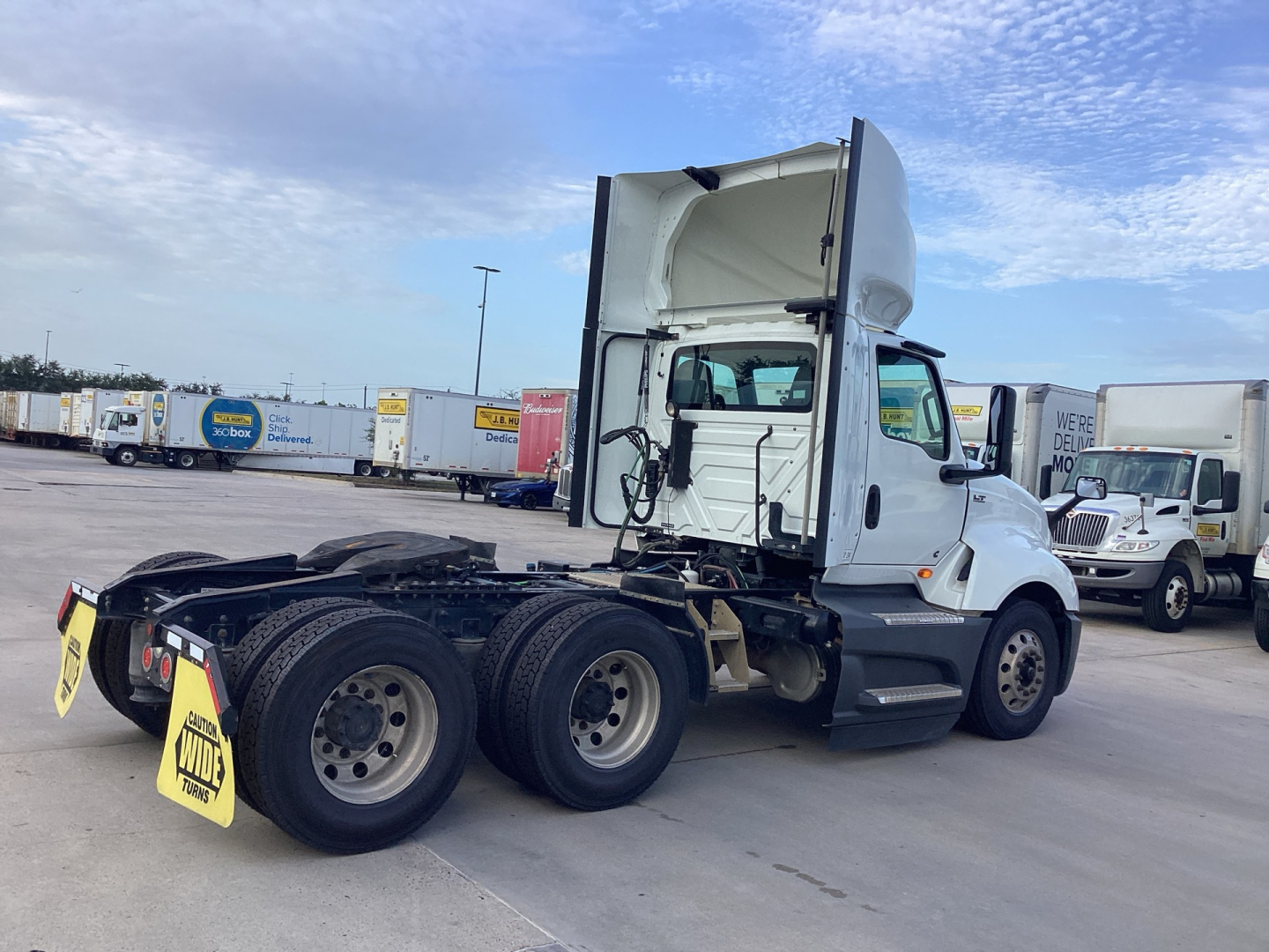 International LT Series day cab tractor showing rear tandem and sleeper cab area with fifth wheel missing and drivetrain exposed.
