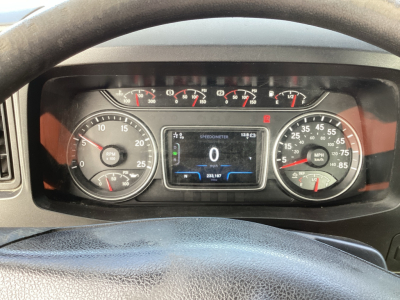Dashboard of a 2021 International LT625 conveyance showing digital speedometer at 0 mph, tachometer, fuel gauges, and warning lights in a truck cab.
