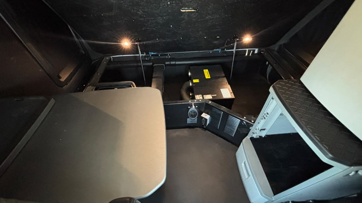 Kenworth T680 cab interior showing bunk area and storage compartments.