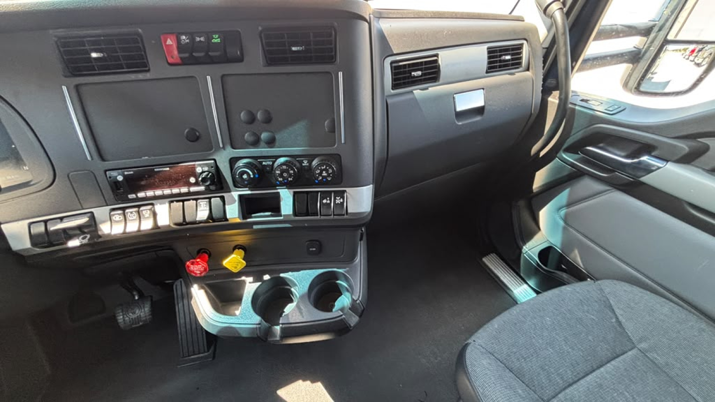 Kenworth T680 truck interior dashboard view showing center console and cup holders.