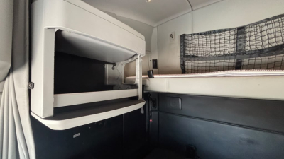 Kenworth T680 cabin interior with sleeping berth and storage compartment visible.