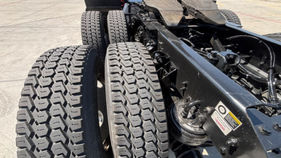 Kenworth T680 truck chassis showing dual rear axles and suspension with visible tires and frame.