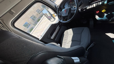 Kenworth T680 truck interior cabin and driver's seat view with steering wheel and dashboard