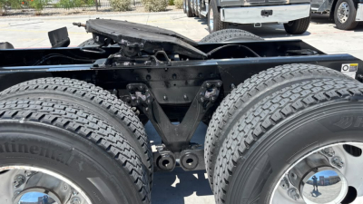 Kenworth T680 chassis rear view showing dual rear axles and frame cross-members with tires and hitch area visible.