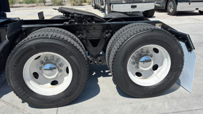 Kenworth T680 truck rear dual wheels showing tires and suspension components.